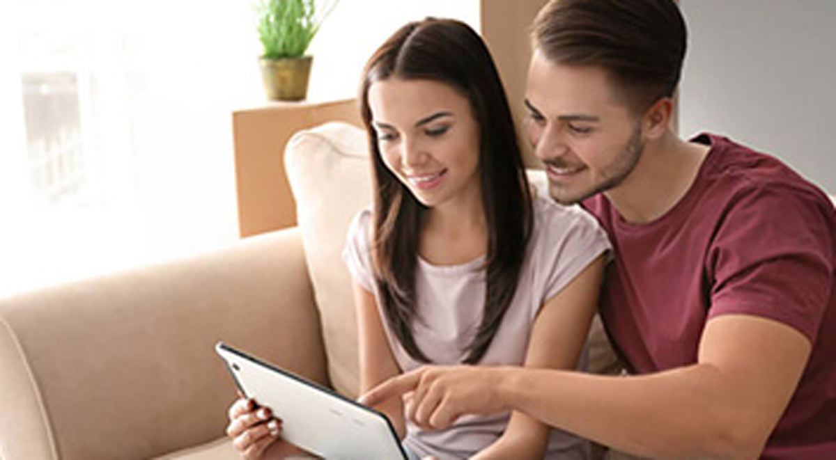 A couple looking at home improvement projects on tablet.