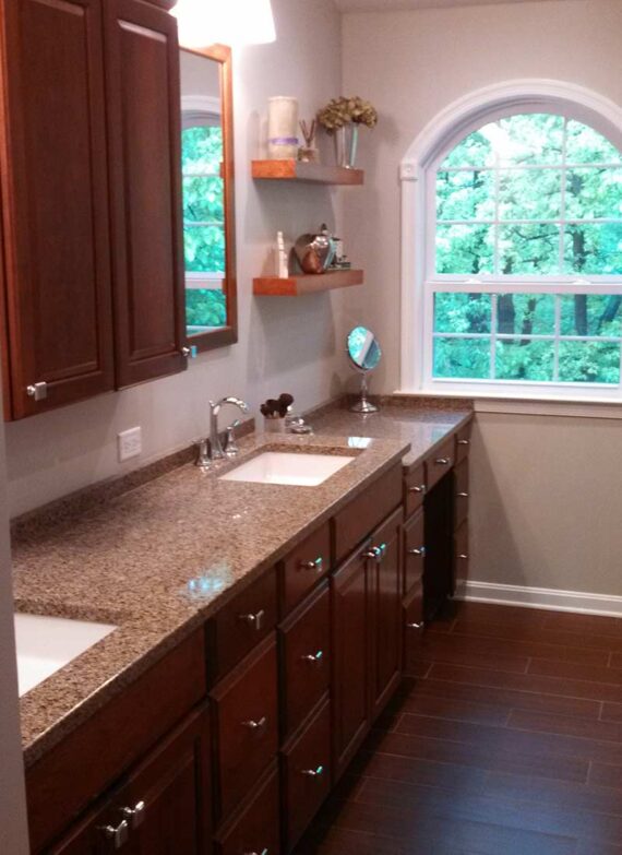 Bathroom remodel with granite countertop and a double sink vanity.