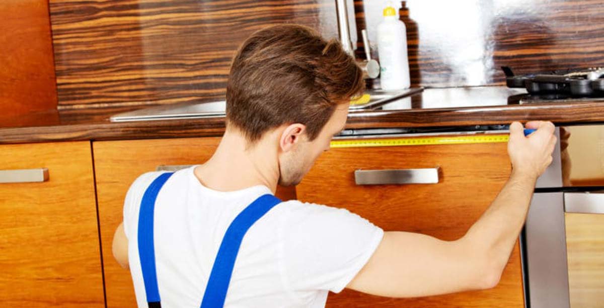 Man creating home improvement project in kitchen.